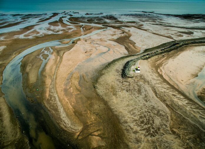 Photo by Ron Whitaker top view photography of house near body of water