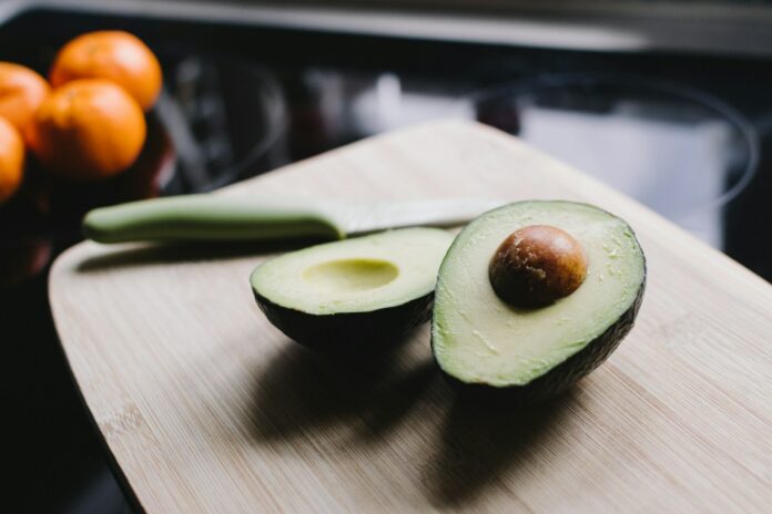 Photo by Kelly Sikkema sliced avocado on brown wooden chopping board