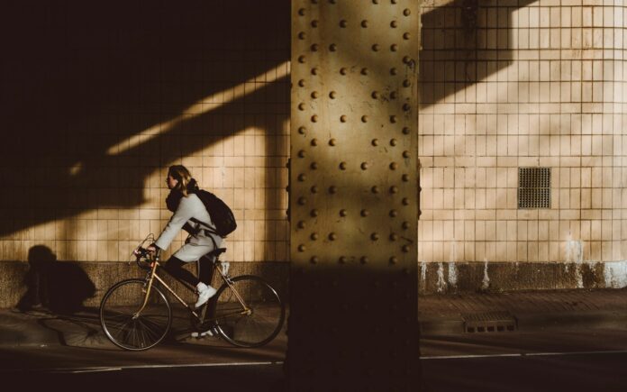 Photo by Marc Kleen person biking under highway