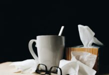 독감과 감기의 차이: 정확히 알고 대처하자 white ceramic mug on white table beside black eyeglasses