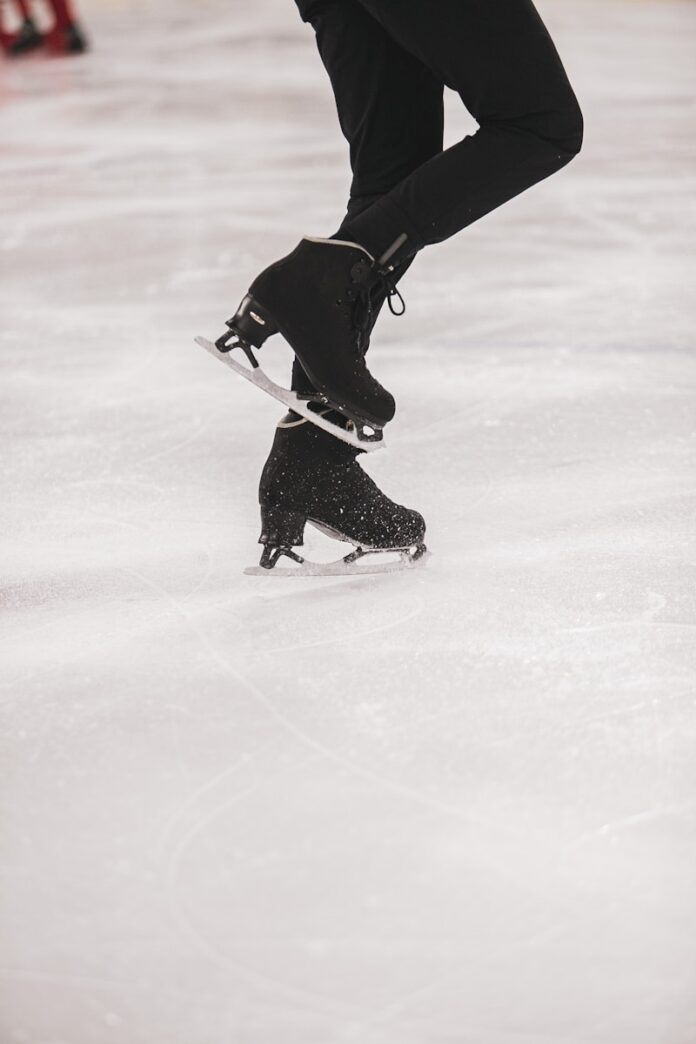 Photo by LOGAN WEAVER | @LGNWVR person in black jacket and black pants playing ice hockey
