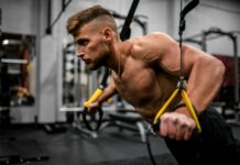 전문가들이 추천하는 어깨 건강을 위한 운동 topless man in black pants holding black and yellow exercise equipment