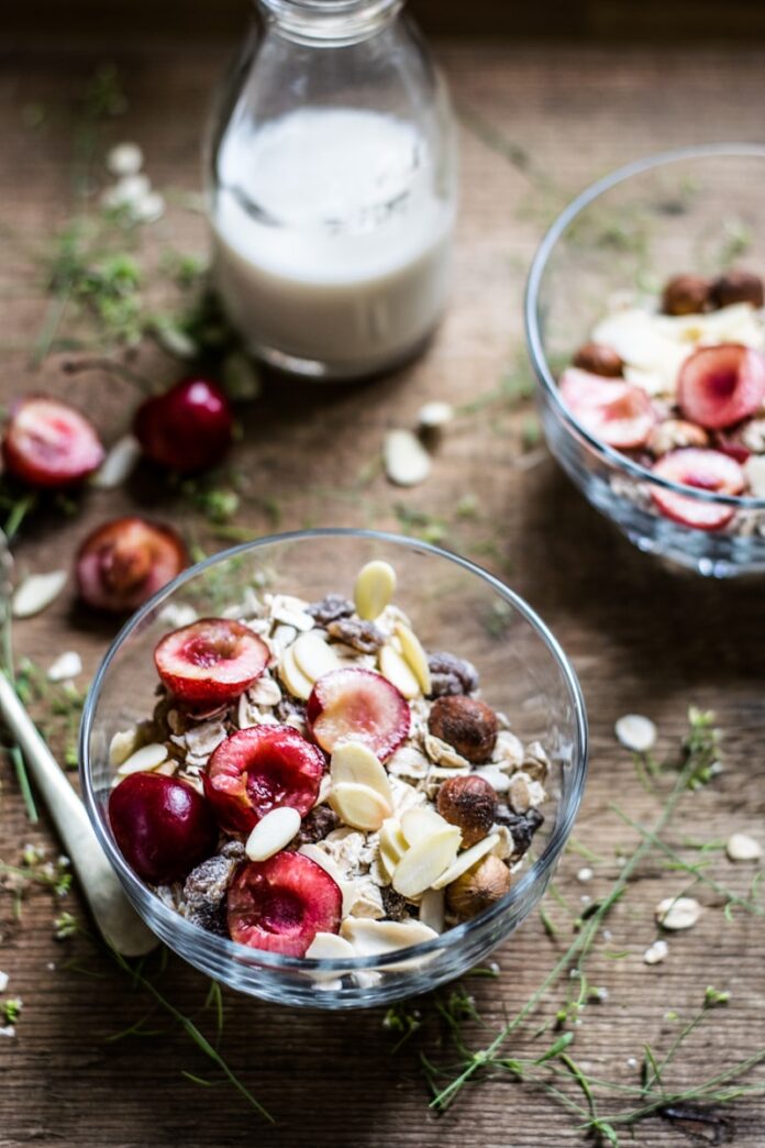 Photo by Monika Grabkowska fruits in clear glass bowl beside milk bottle