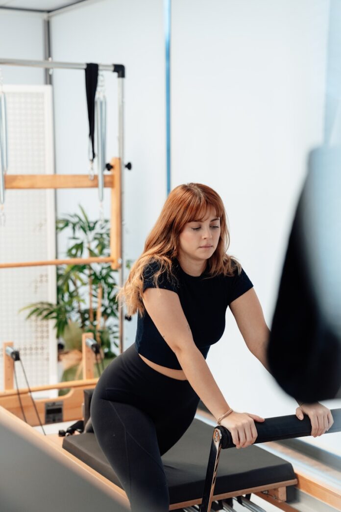 Photo by Ahmet Kurt a woman on a rowing machine in a gym