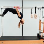 필라테스, 건강한 몸과 마음을 위한 최고의 선택 a woman doing a handstand on a pivot machine